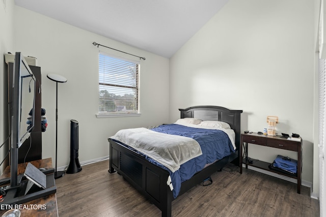 bedroom with lofted ceiling and dark hardwood / wood-style flooring