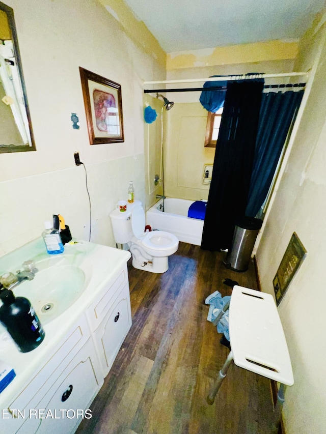 full bathroom featuring shower / bath combo, hardwood / wood-style floors, vanity, and toilet