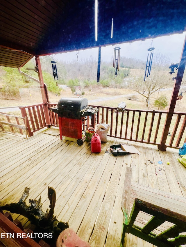 wooden deck featuring a grill