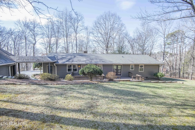 ranch-style house featuring a carport and a front lawn