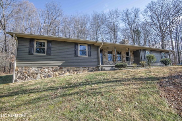 single story home featuring covered porch and a front yard