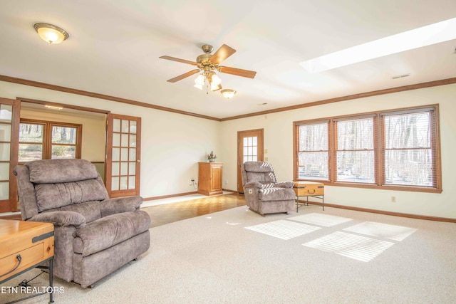 living area featuring ornamental molding, plenty of natural light, and carpet floors