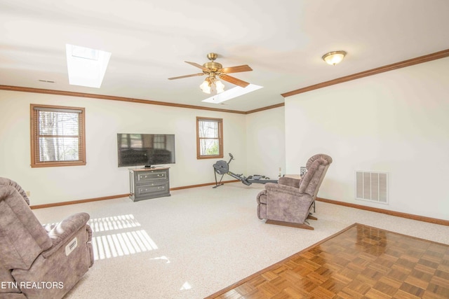 living room featuring crown molding, a skylight, a wealth of natural light, and parquet flooring