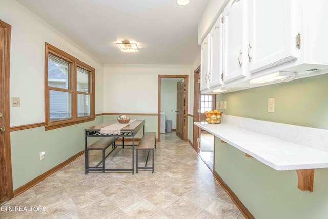 kitchen with a healthy amount of sunlight and white cabinets