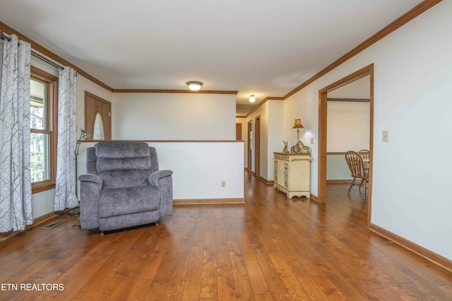 living area featuring crown molding and wood-type flooring