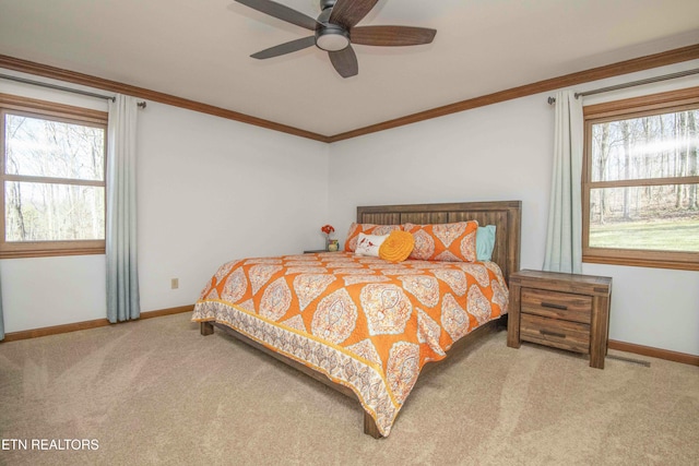 bedroom featuring crown molding, ceiling fan, and carpet