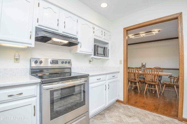 kitchen featuring stainless steel appliances, light wood-type flooring, and white cabinets