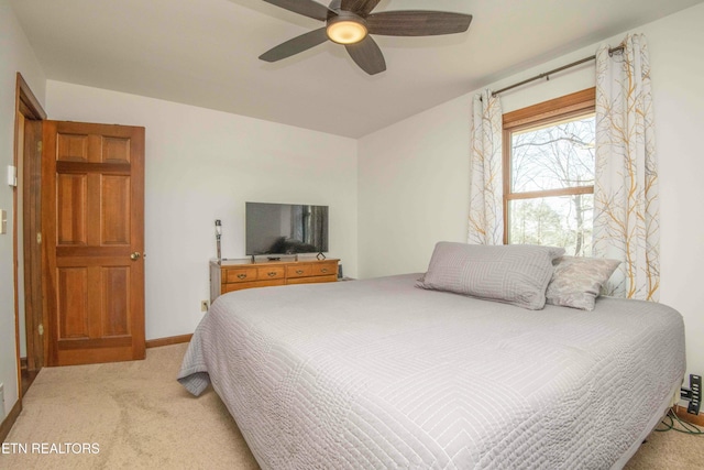 bedroom featuring light colored carpet and ceiling fan