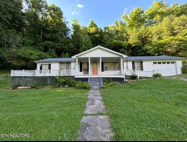 view of front of property featuring a garage, a porch, and a front lawn