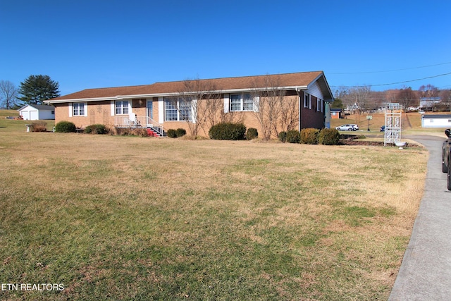 ranch-style house with a front lawn and brick siding