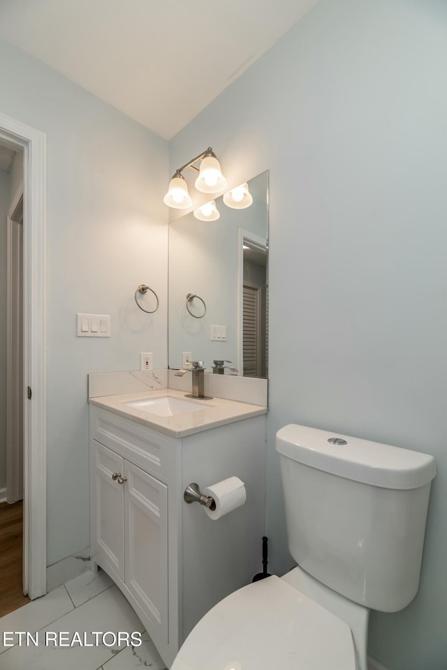 bathroom featuring tile patterned floors, vanity, and toilet