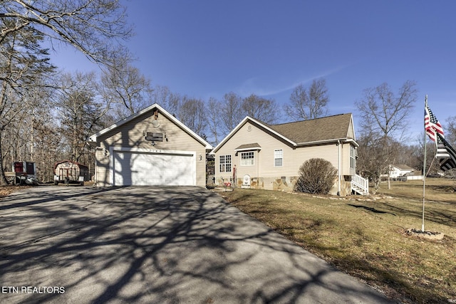 view of front of home featuring a garage and a front lawn