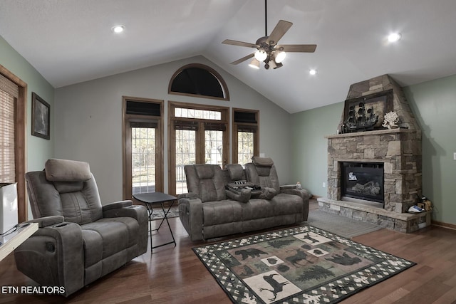 living room featuring dark hardwood / wood-style flooring, a fireplace, lofted ceiling, and ceiling fan