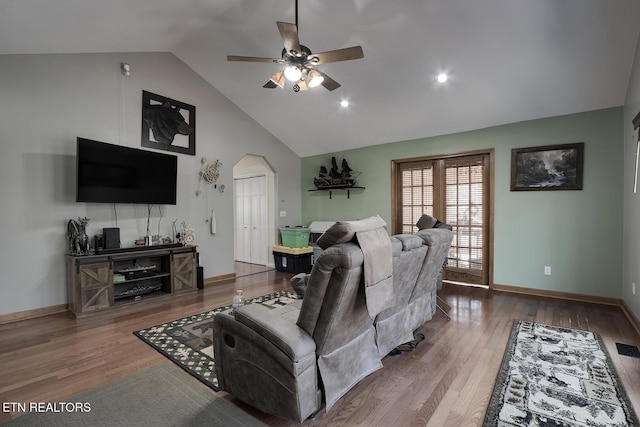 living room featuring hardwood / wood-style floors, high vaulted ceiling, and ceiling fan