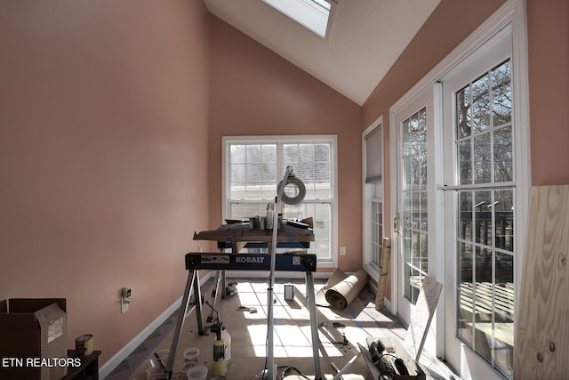 exercise area with lofted ceiling with skylight