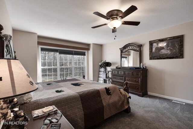 bedroom featuring ceiling fan, carpet flooring, and multiple windows