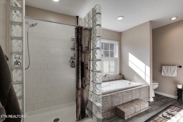 bathroom featuring toilet, separate shower and tub, and hardwood / wood-style floors