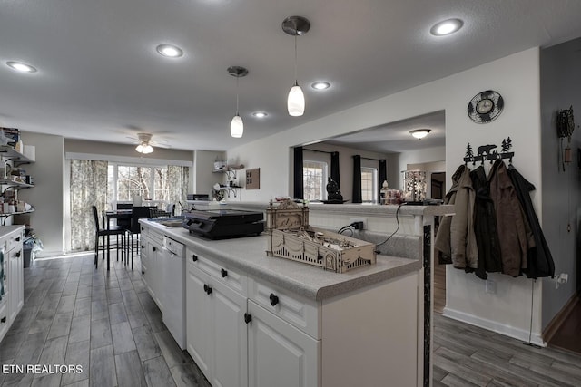 kitchen featuring a kitchen island, pendant lighting, white cabinetry, dishwasher, and ceiling fan