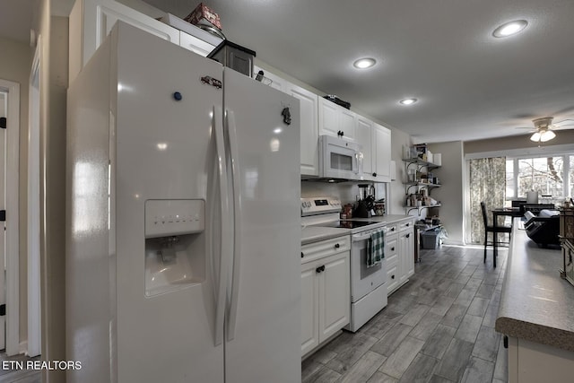 kitchen with white cabinetry, white appliances, and ceiling fan