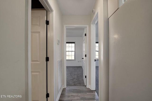 corridor featuring dark hardwood / wood-style floors