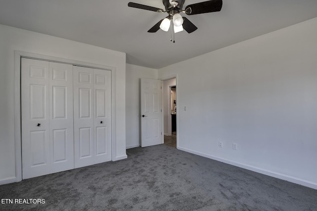 unfurnished bedroom featuring dark colored carpet, ceiling fan, and a closet