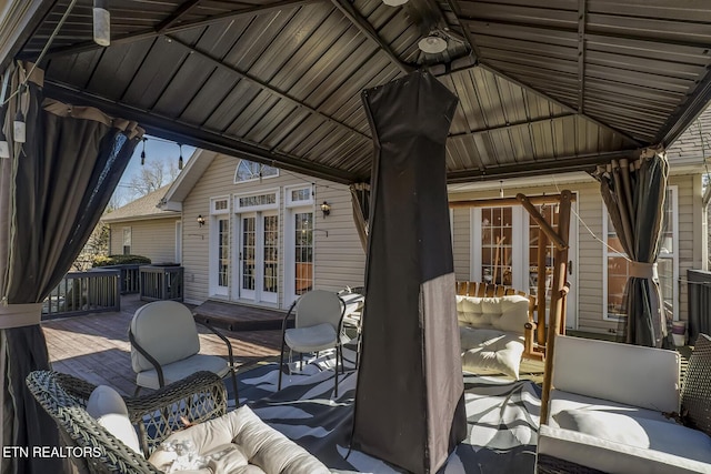 wooden deck with a gazebo and french doors