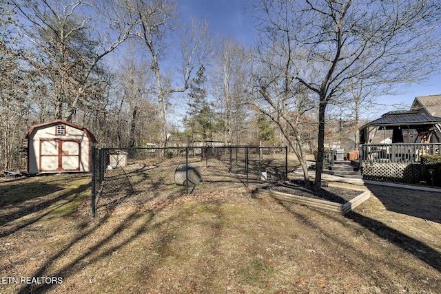 view of yard with a gazebo, a storage unit, and a wooden deck