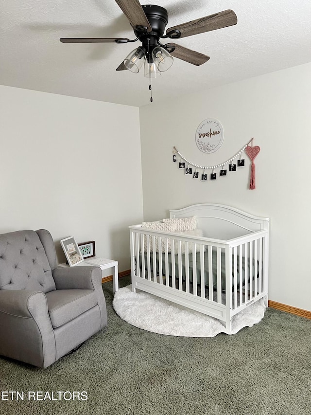 carpeted bedroom featuring a ceiling fan, baseboards, and a textured ceiling