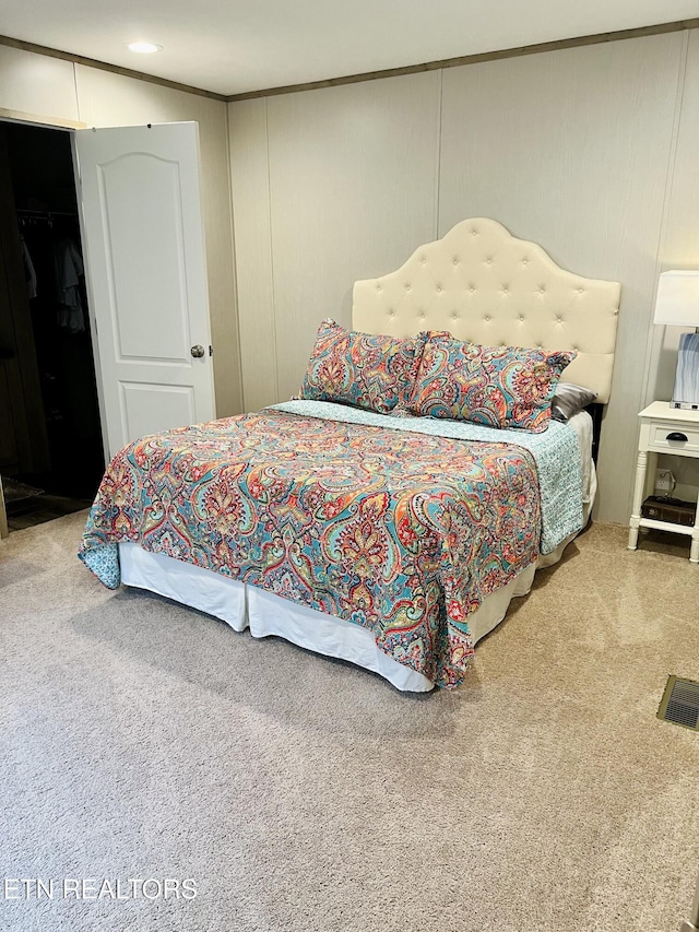 carpeted bedroom featuring visible vents