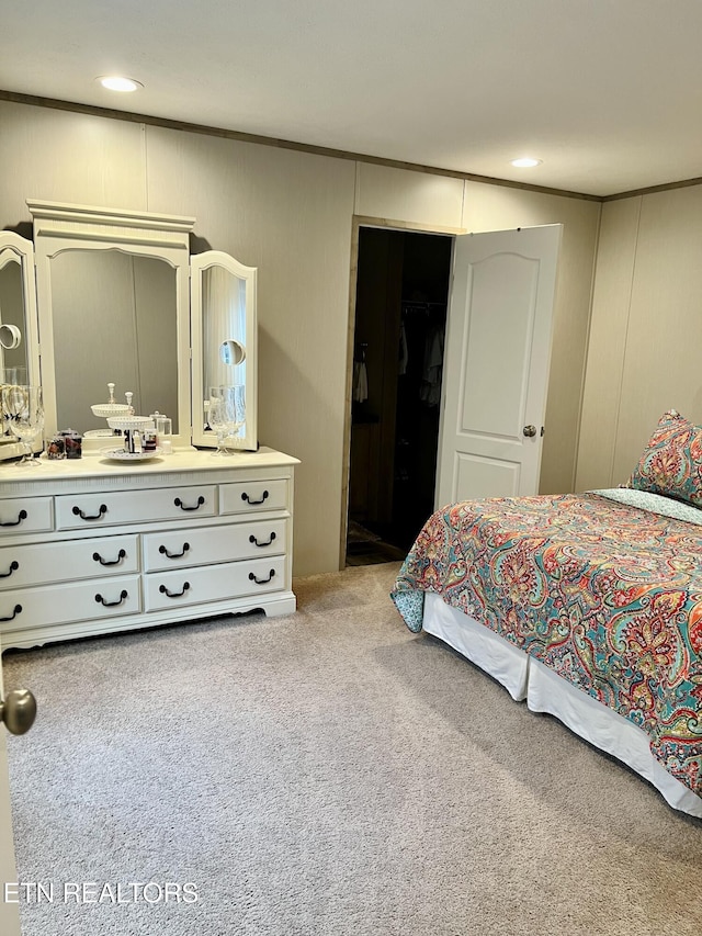 bedroom with carpet, ornamental molding, a decorative wall, and recessed lighting