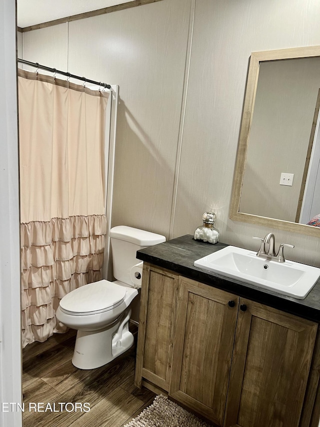 full bathroom with a shower with curtain, vanity, toilet, and wood finished floors