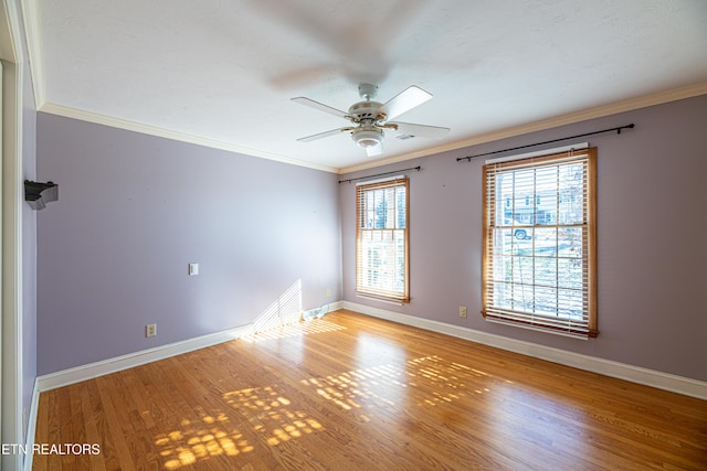 spare room featuring ceiling fan, ornamental molding, and light hardwood / wood-style flooring