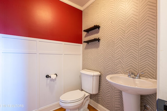 bathroom with ornamental molding and toilet