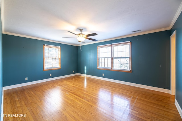 unfurnished room with crown molding, ceiling fan, and wood-type flooring