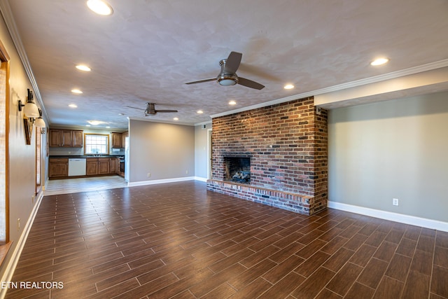 unfurnished living room featuring ornamental molding, a brick fireplace, and ceiling fan