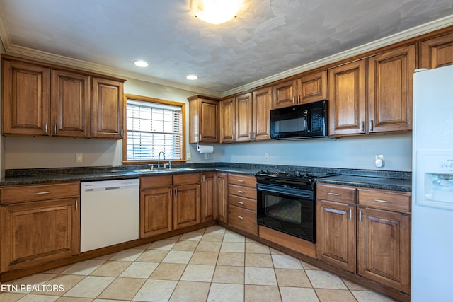 kitchen featuring dark stone countertops, sink, ornamental molding, and black appliances