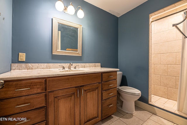 bathroom with toilet, vanity, tile patterned floors, and walk in shower