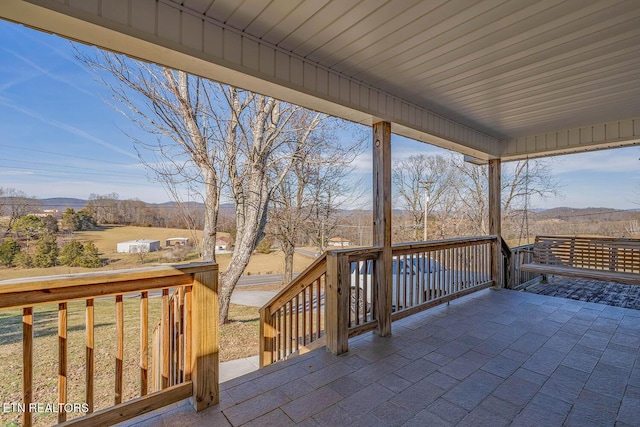 wooden terrace with a patio area