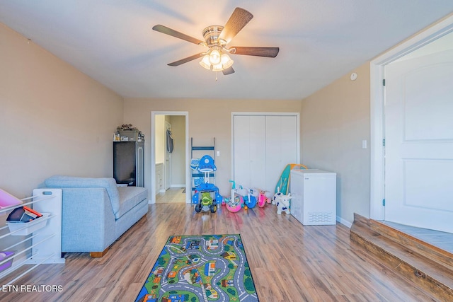 game room featuring ceiling fan and light wood-type flooring