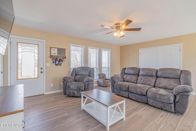 living room with ceiling fan and light wood-type flooring