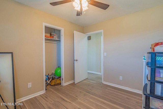 unfurnished bedroom featuring light hardwood / wood-style flooring, a closet, and ceiling fan