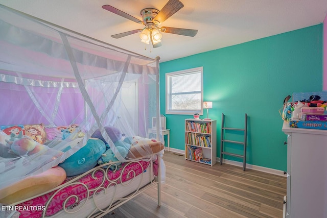 bedroom featuring hardwood / wood-style flooring and ceiling fan