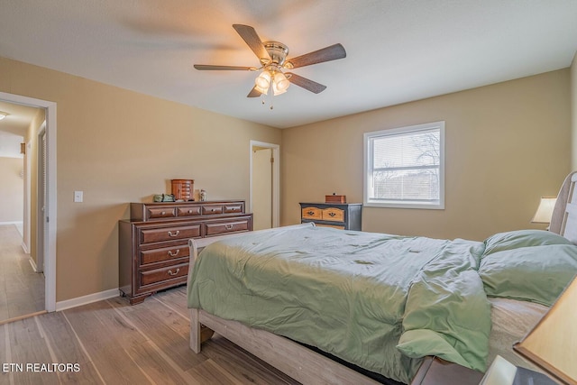 bedroom with ceiling fan and light hardwood / wood-style flooring