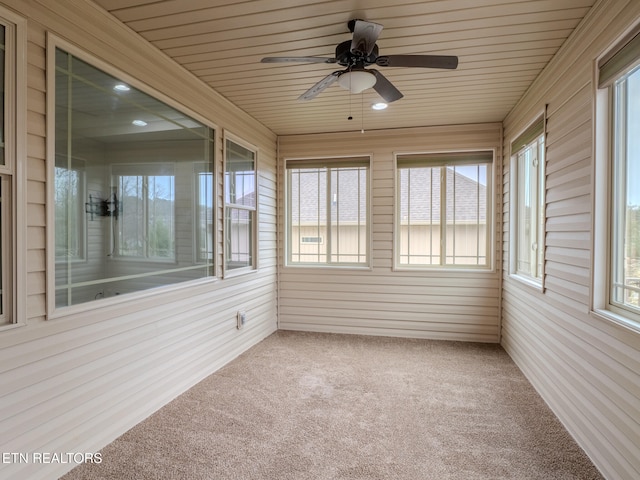 unfurnished sunroom featuring wooden ceiling and ceiling fan