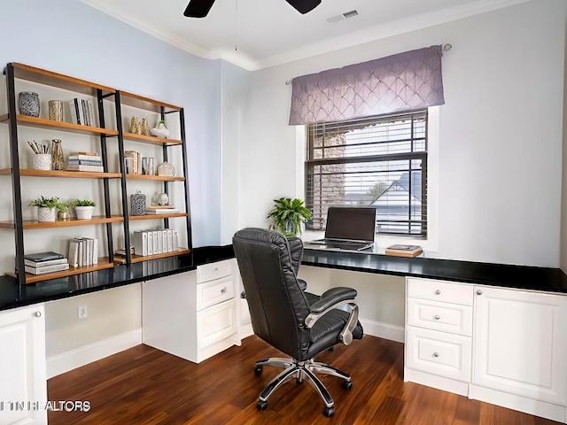 home office with crown molding, dark hardwood / wood-style floors, built in desk, and ceiling fan