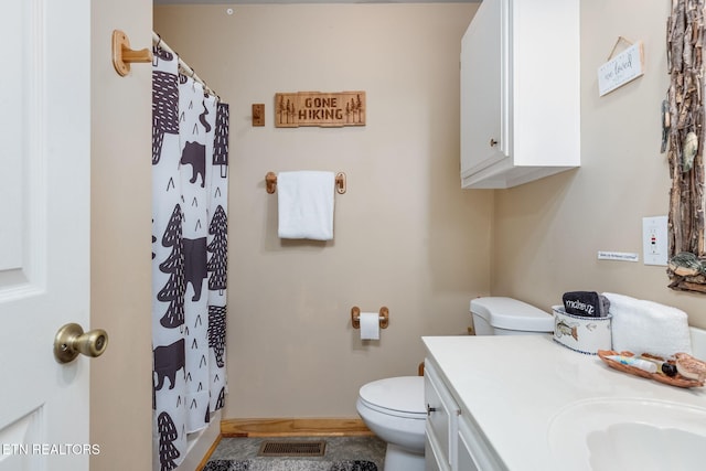 bathroom featuring vanity, a shower with curtain, and toilet