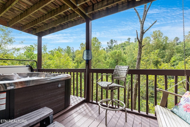 wooden deck with a hot tub