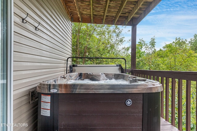 wooden terrace with a hot tub