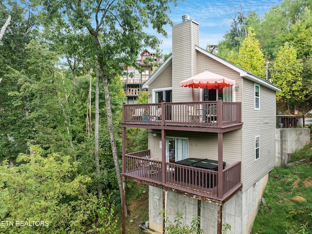 back of house featuring a wooden deck