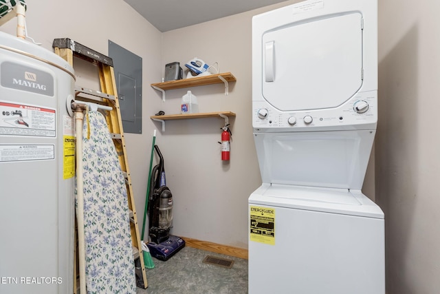 clothes washing area with stacked washer / drying machine and electric panel